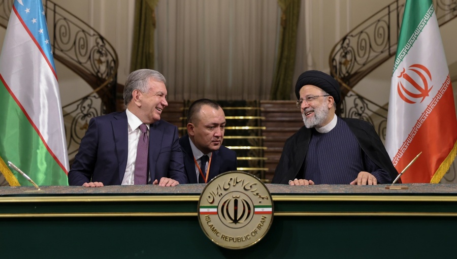 Uzbek President Mirziyoyev, left, signing deals with Iranian counterpart Ebrahim Raisi in the last shah's former palace in Tehran.