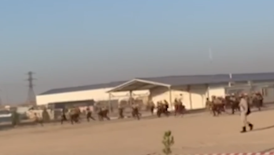 Workers seen running towards the company building that was ransacked.