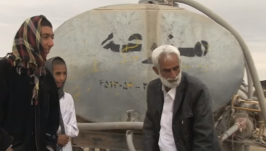 Iranian nomadic herders supplied with water from local authority tankers.