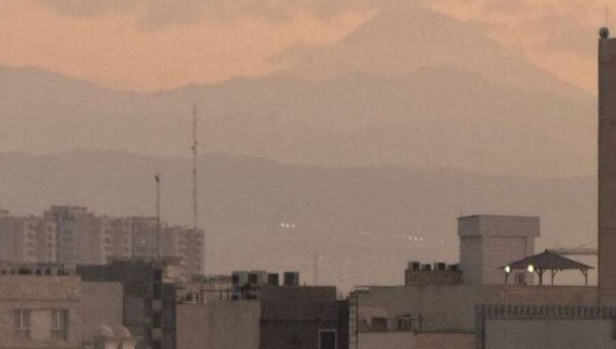 Damavand mountain appears from thick smog in Tehran.